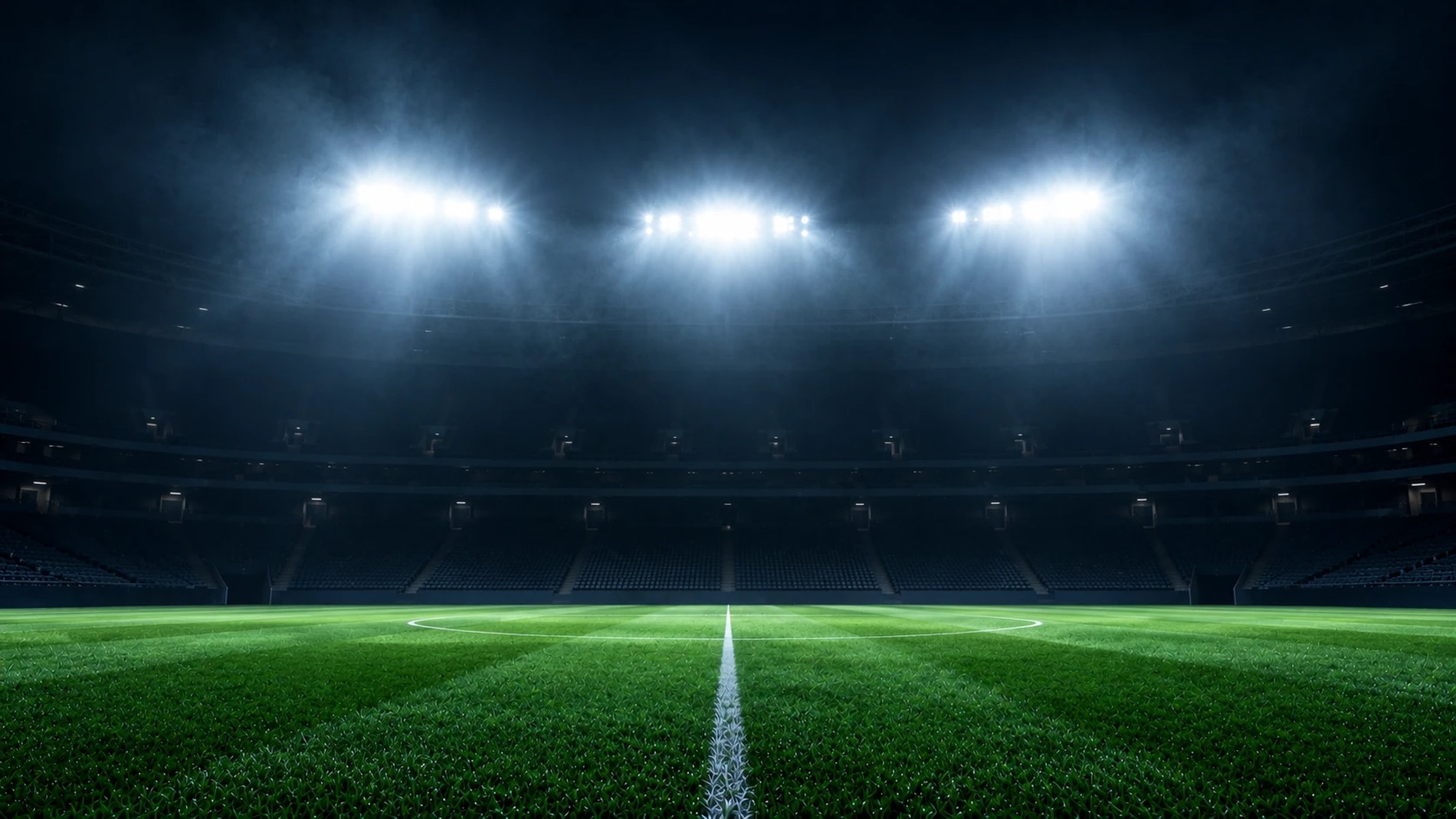 照明に照らされた夜のサッカースタジアム